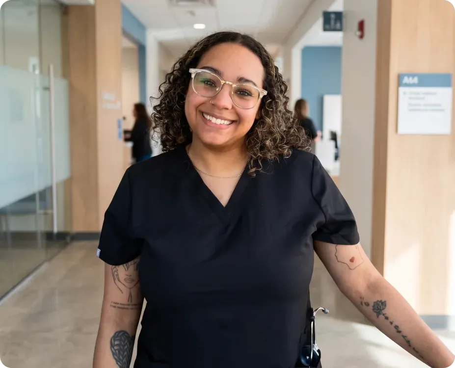 A BSN-prepared nurse walking through a hospital corridor