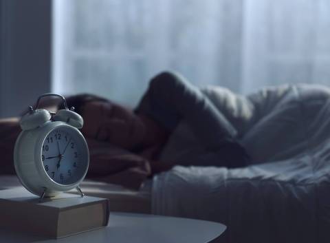 alarm clock and person sleeping for school