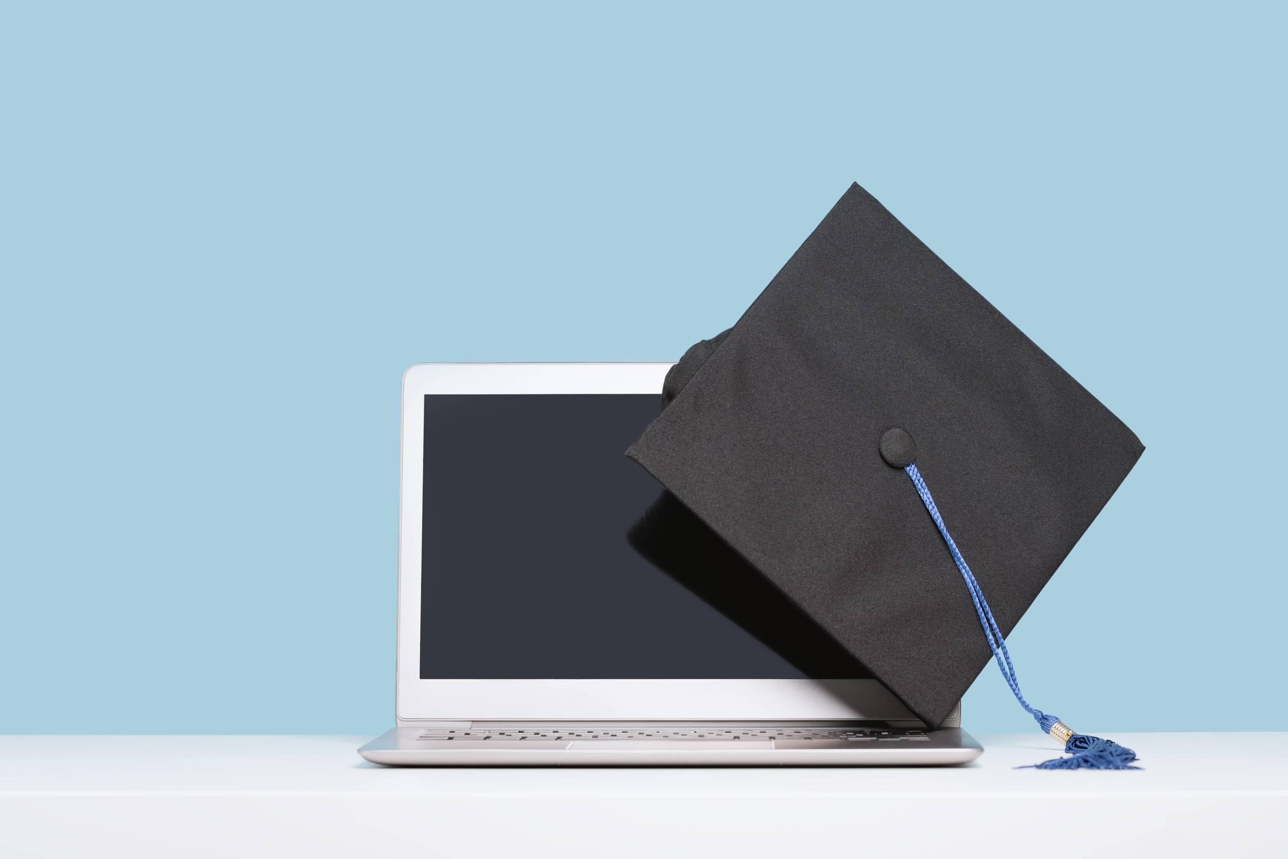 college cap and laptop-min college cap and laptop computer