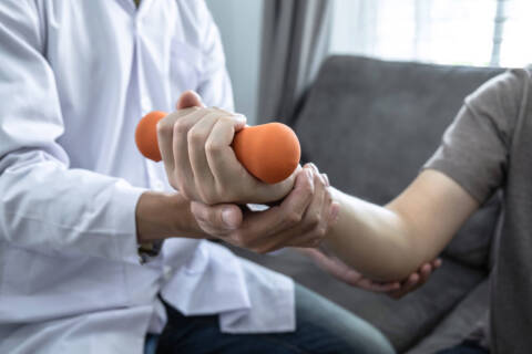 Doctor physiotherapist treating rehabilitation arm pain patient can physical therapy help arthritis?