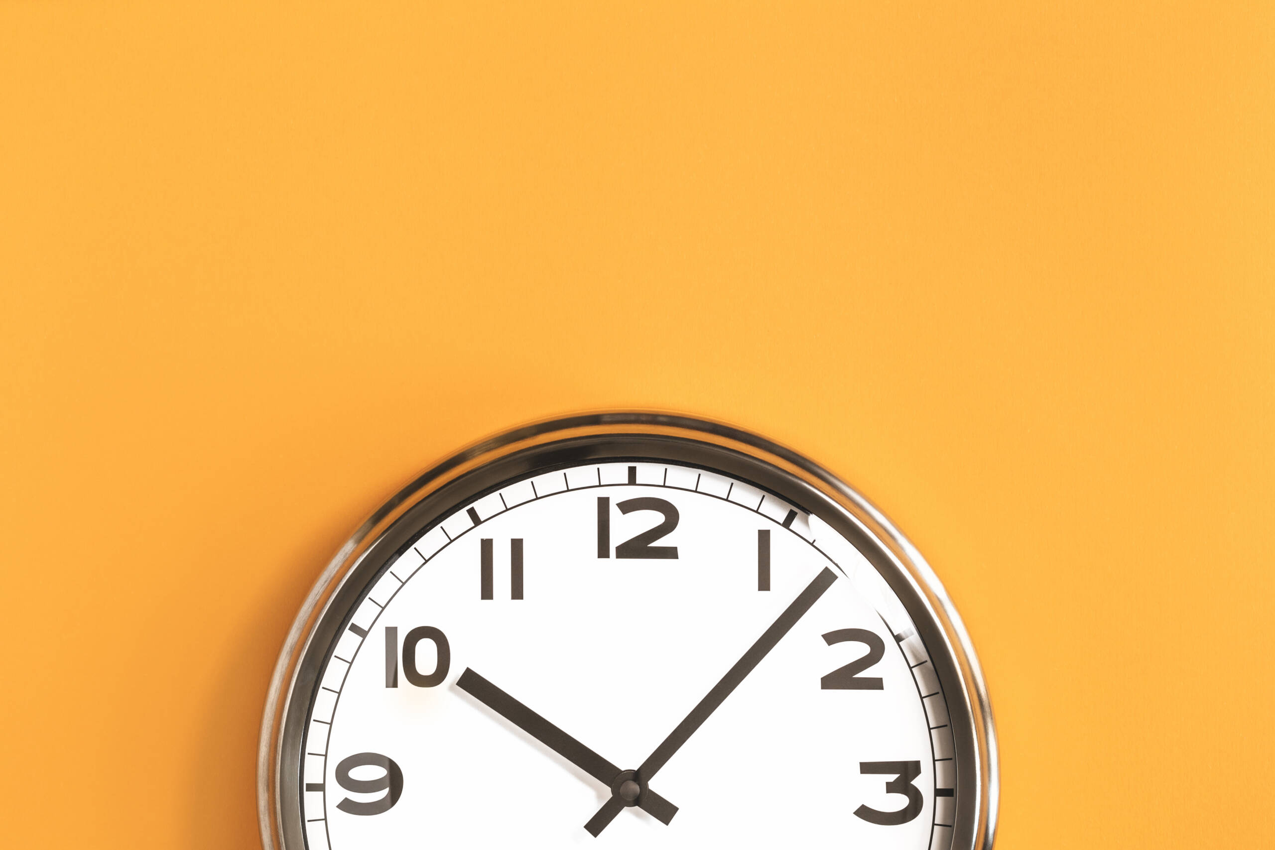 Part of big wall clock on orange background clock on a yellow wall