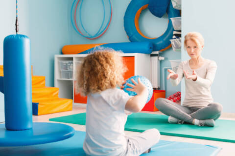 a child is working with an occupational therapist in pediatric care