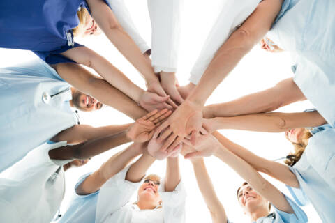 Multiethnic Medical Team Stacking Hands teamwork in nursing